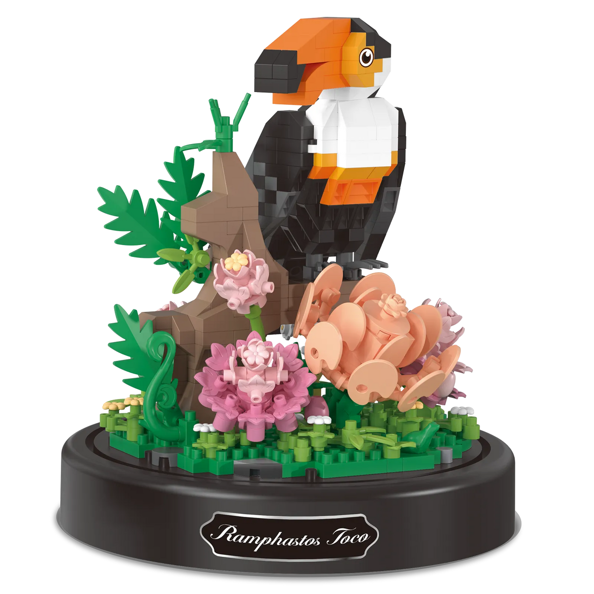 Productfoto van de Balody miniblocks op een tak zittende toekan met bloemen, onder een stolp